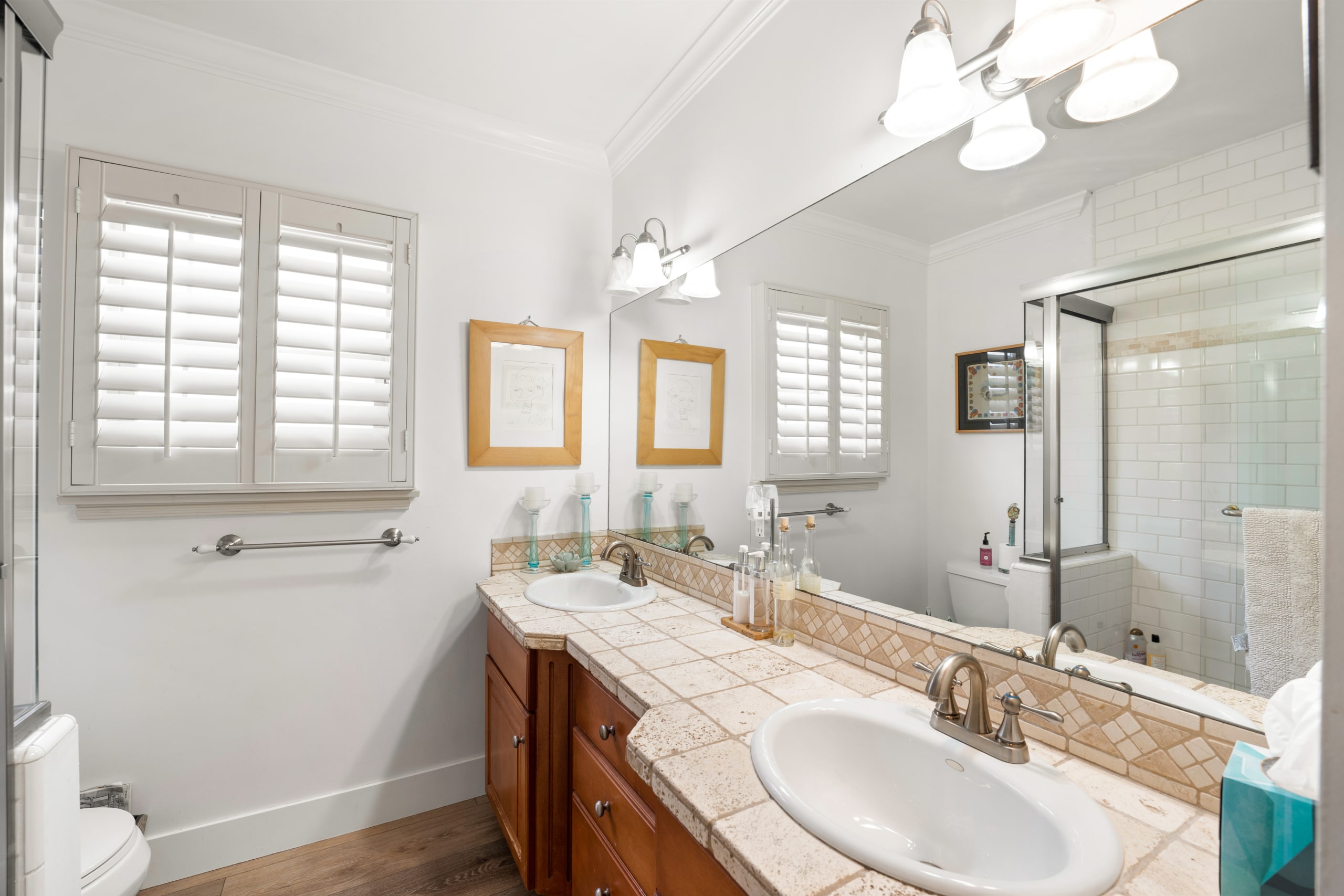 Modern bathroom vanity unit with sink, lightening and window view in 11323 Valley Spring Lane