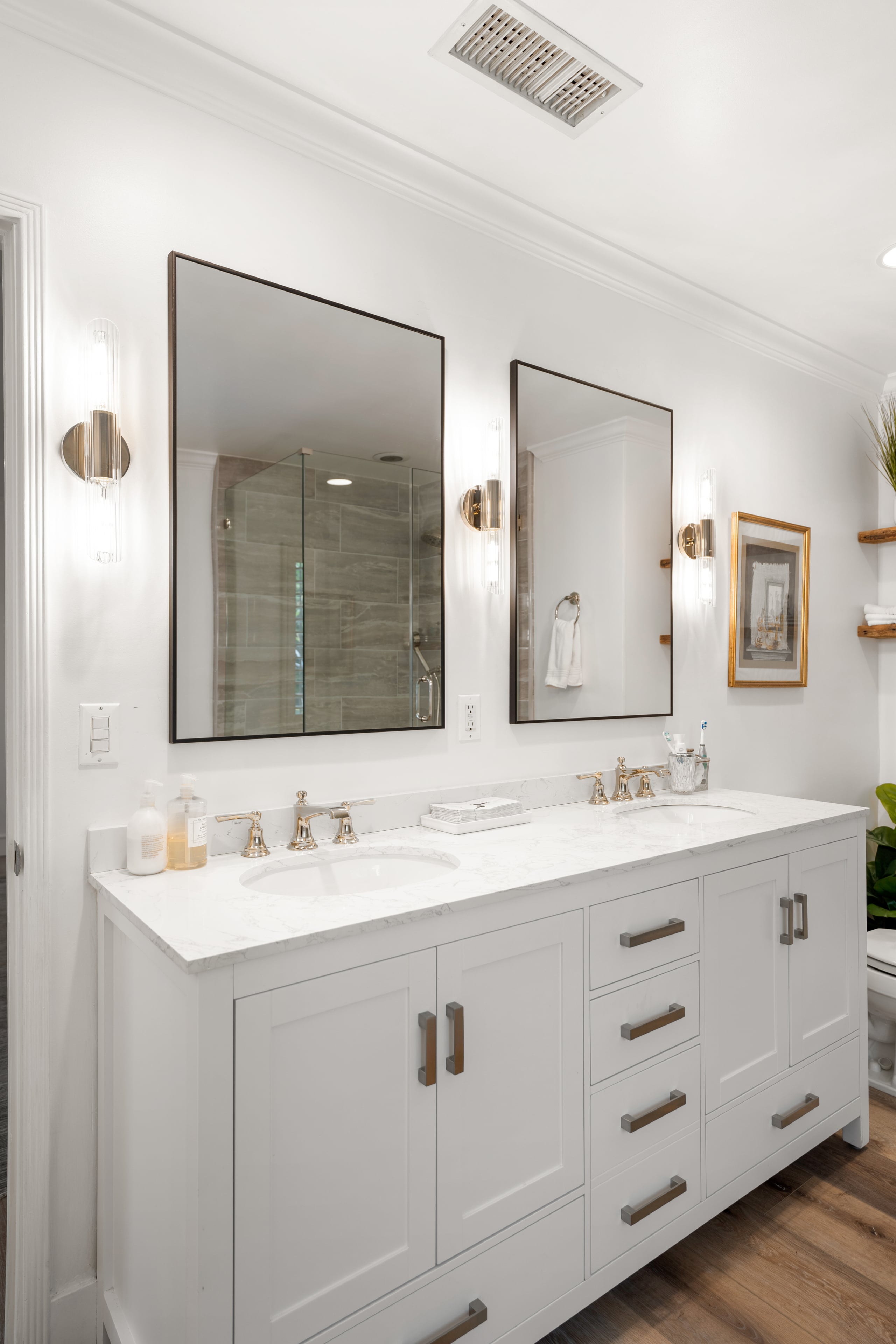 bathroom white shelves, wall mirror and beautiful wall frame of a property in 11323 Valley Spring Lane