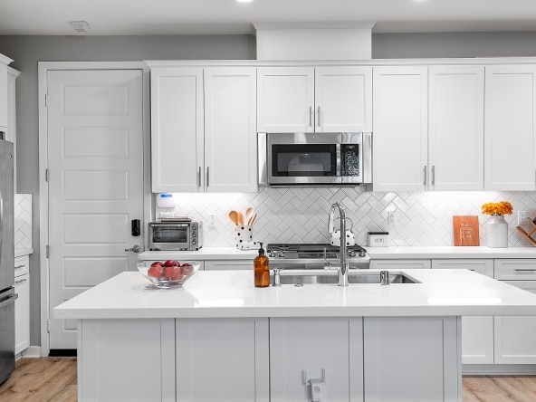 Kitchen island in a Kitchen and oven hung on a cabinet at 19529 Astor Place