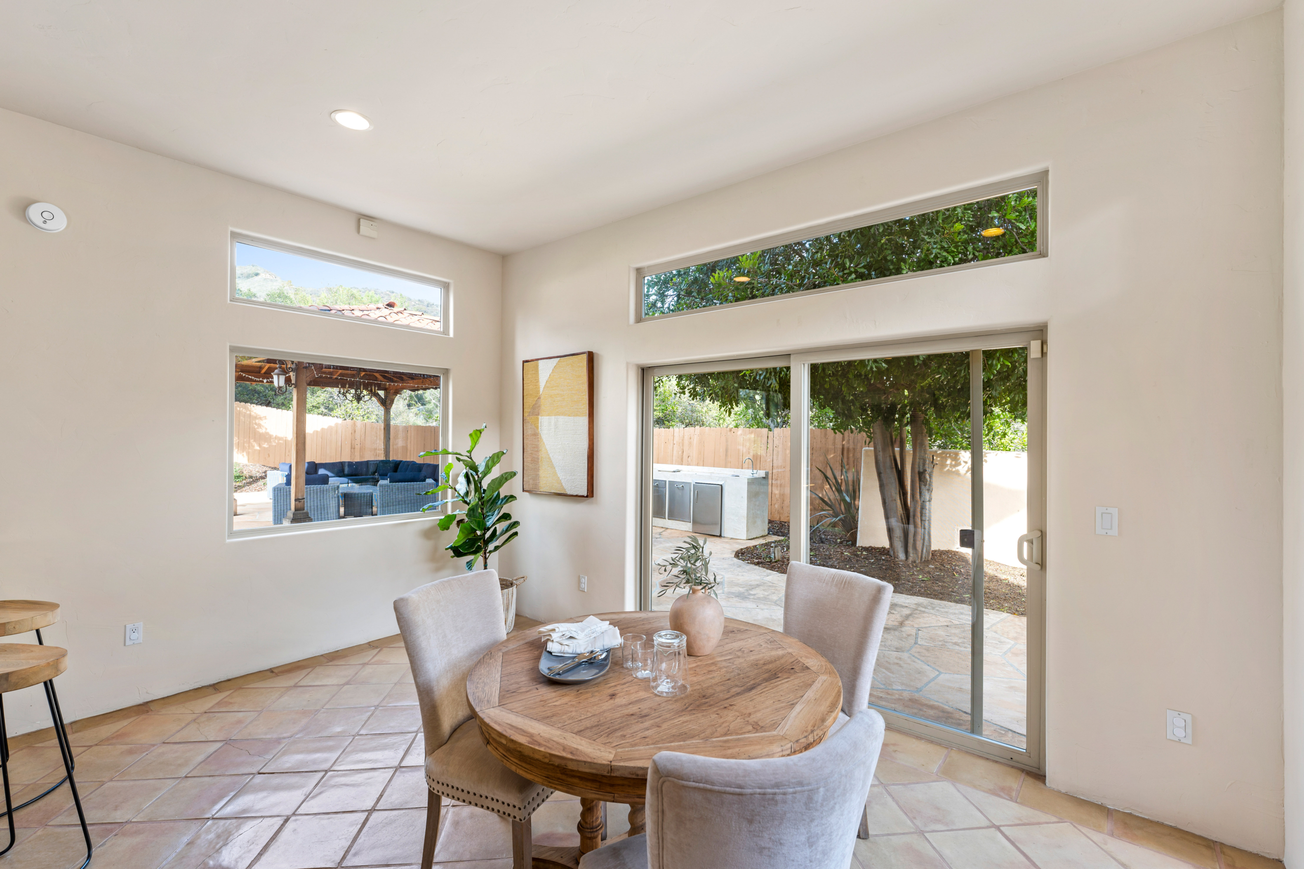 Dining room with glass slide doors, dining set and wall frame at 2175 Cold Canyon Road Calabasas
