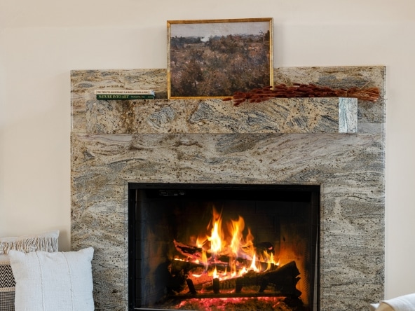 Living room with armchair , stone built fireplace at 2175 Cold Canyon Road Calabasas