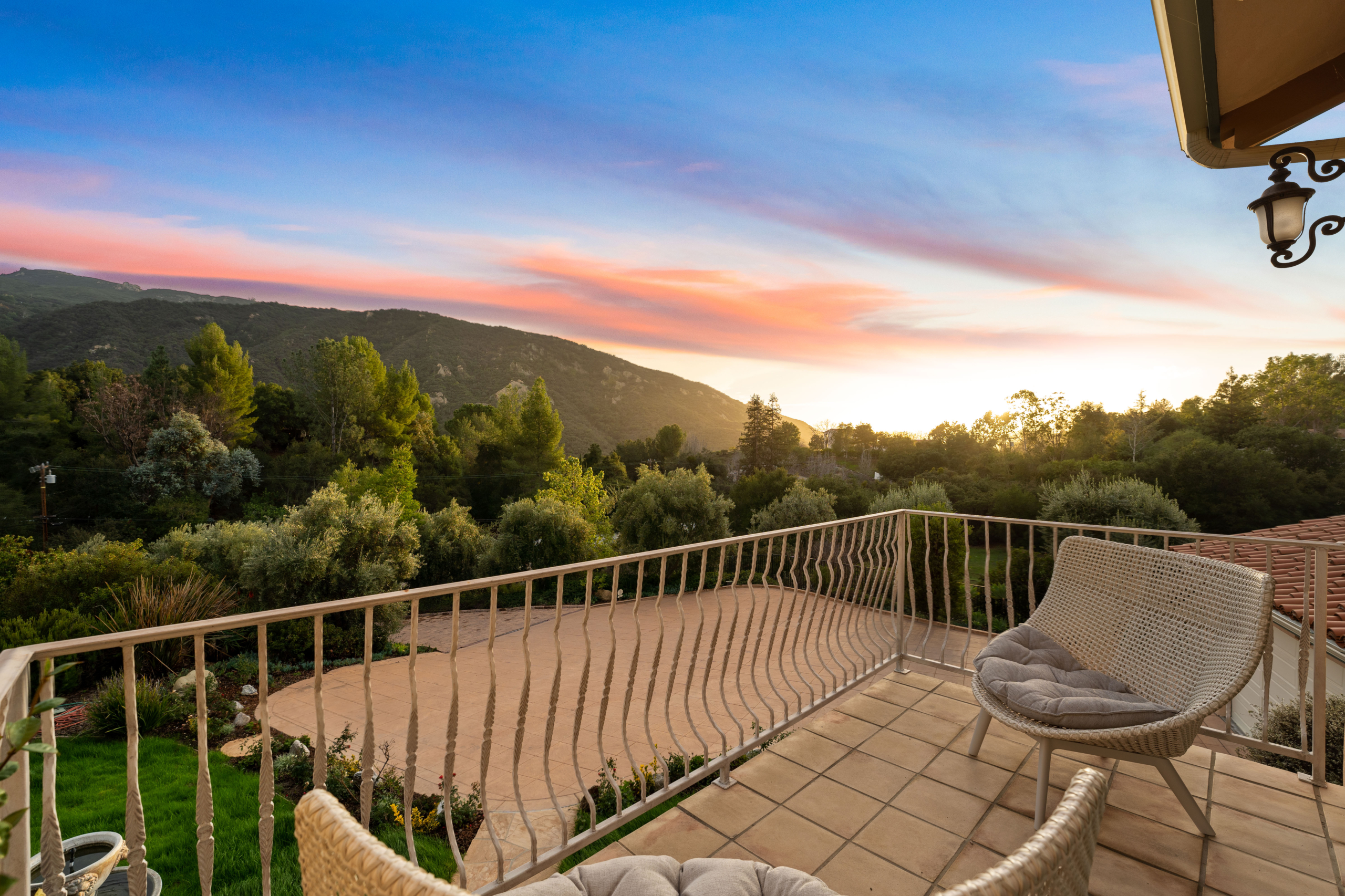 Balcony view of a house property with woven chair, and trees at 2175 Cold Canyon Road Calabasas