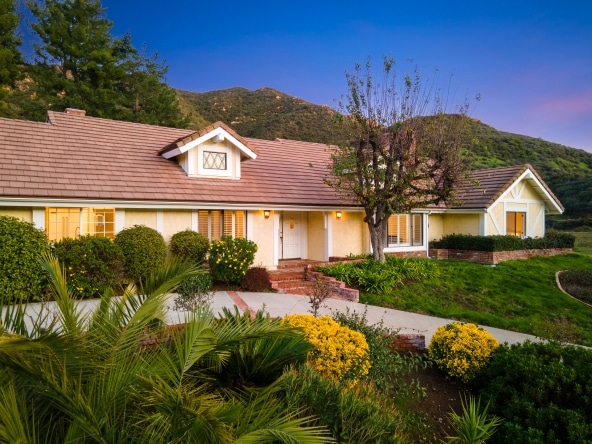 house property front view with rose flowers decoration in 24592 Mulholland Highway